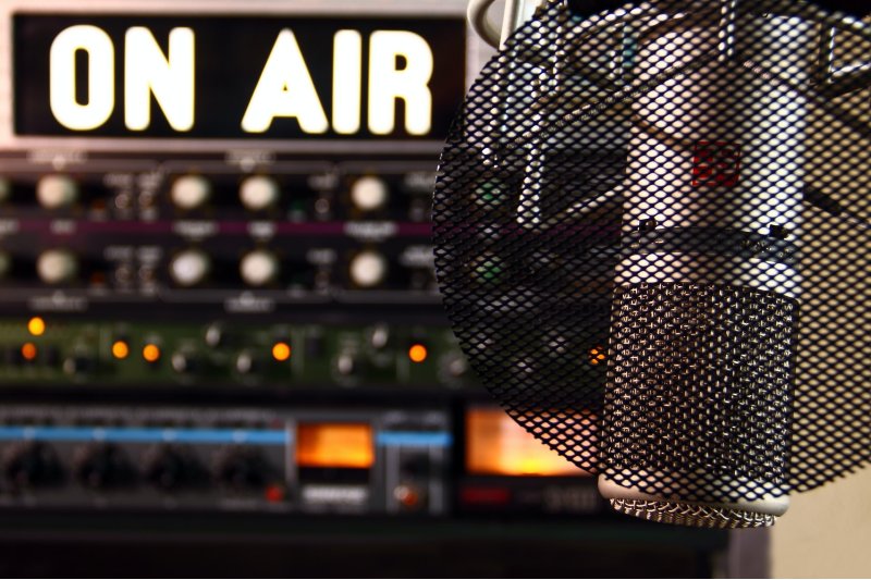 Photo of a radio station mic and an on air sign