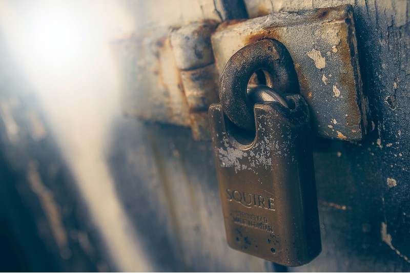 Photo of a padlock locked across a door