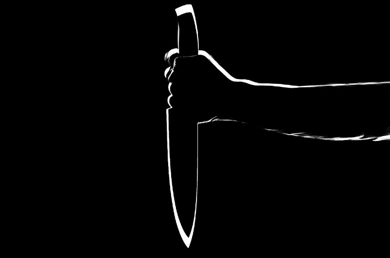 Stylized photo of a shadowed hand holding a knife