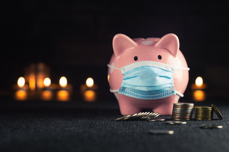 Photo of a piggy bank wearing a disposable mask