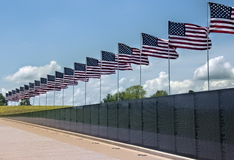 Photo of American Flags flying over the Vietnam Memorial