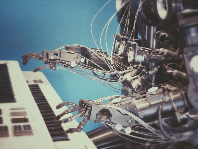 Photo of a robot playing a keyboard piano