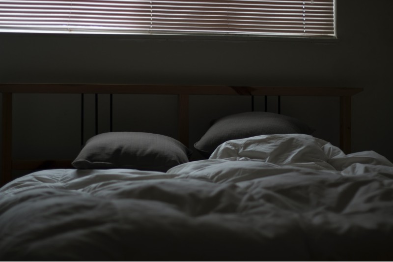 Photo of an empty and unmade bed
