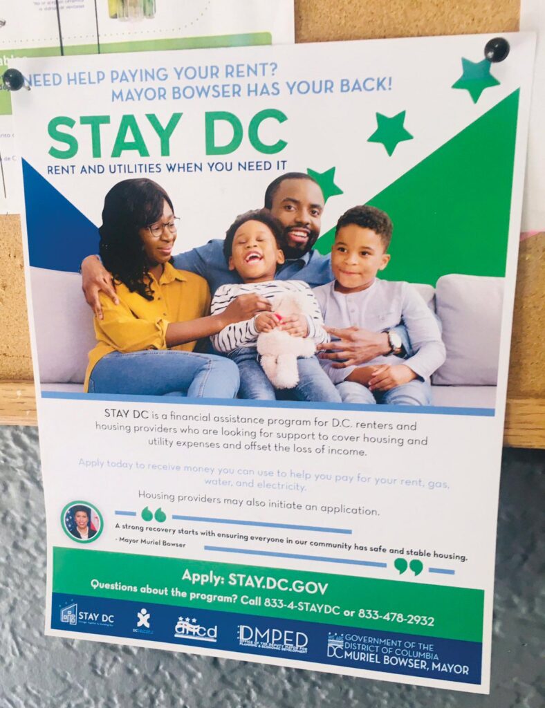 Photo shows flyer for STAY DC rent assistance on a bulletin board.