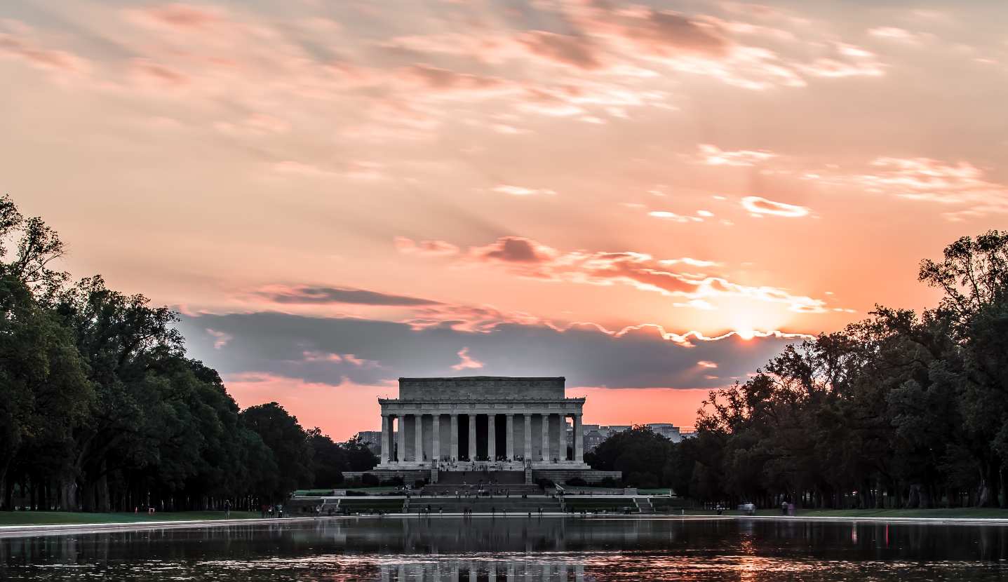Photo of the Lincoln Memorial with a sunset in the bacgkround.