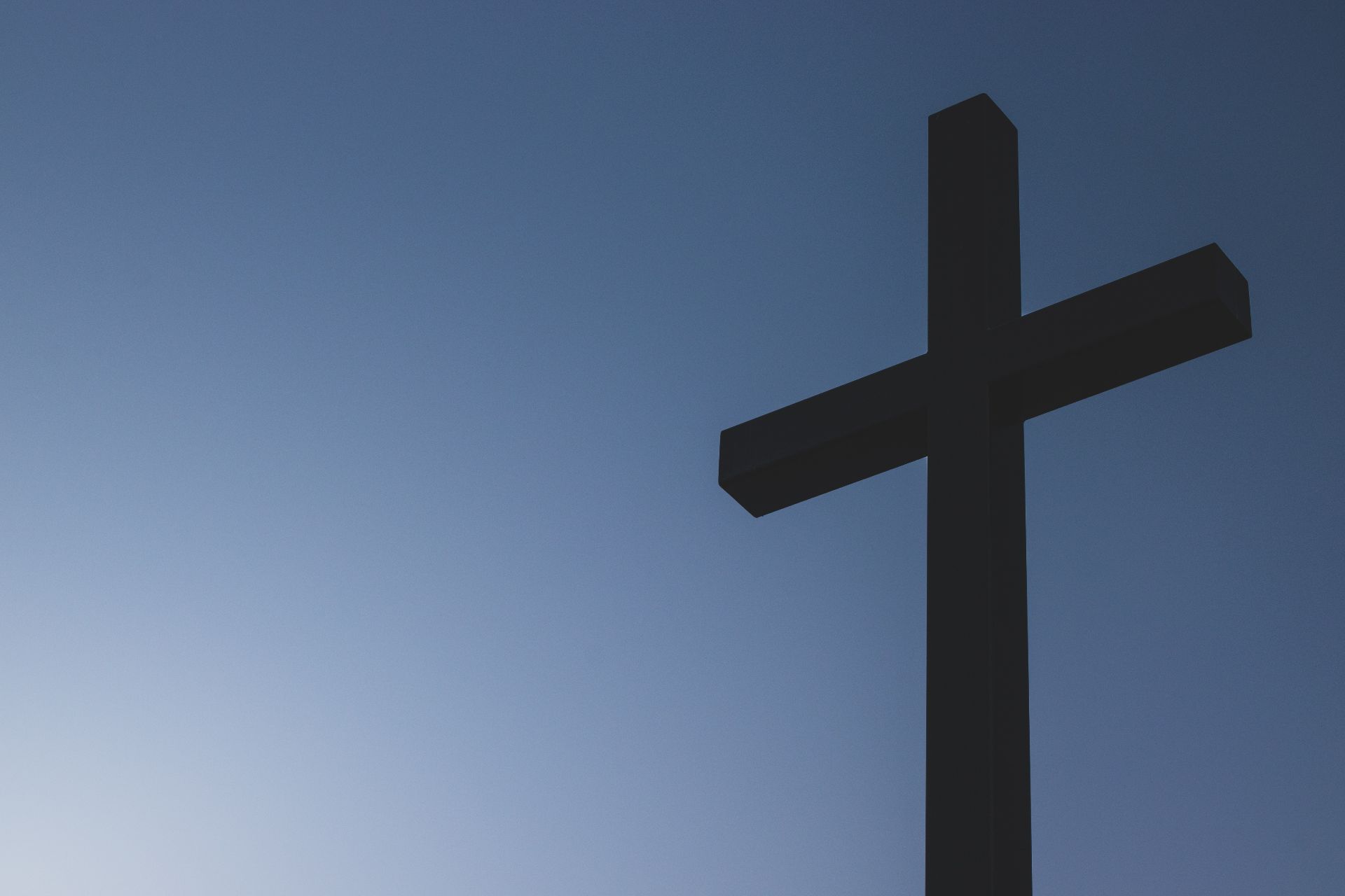 Photo of a cross against a blue sky.