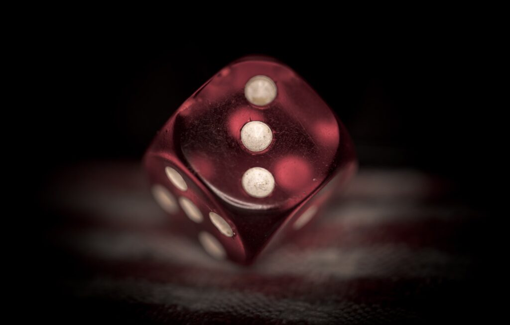 Photo of a dice showing the "three" side.