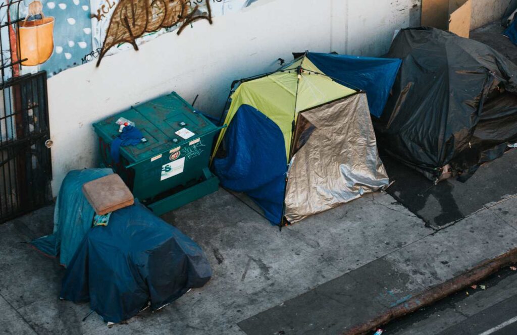 Photo of a homeless encampment on a sidewalk.