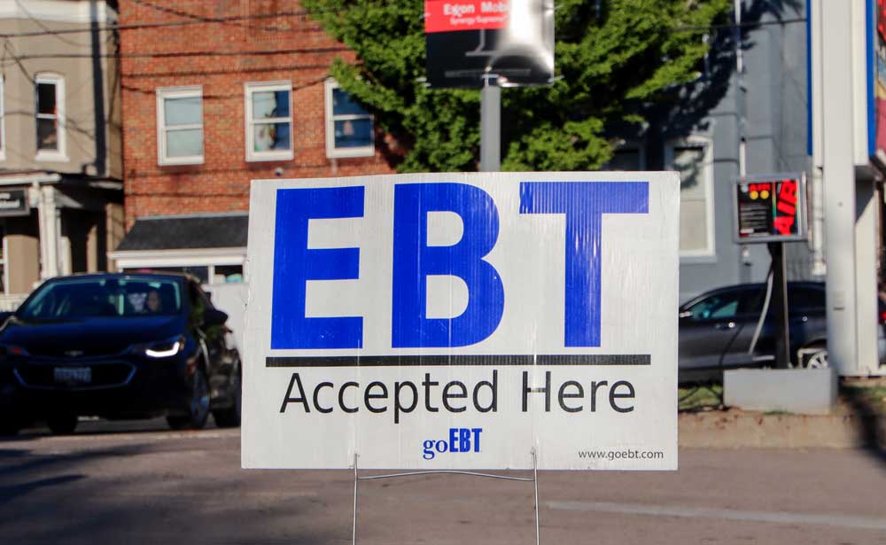 Photo of a sign stuck in the ground that says "EBT accepted here."