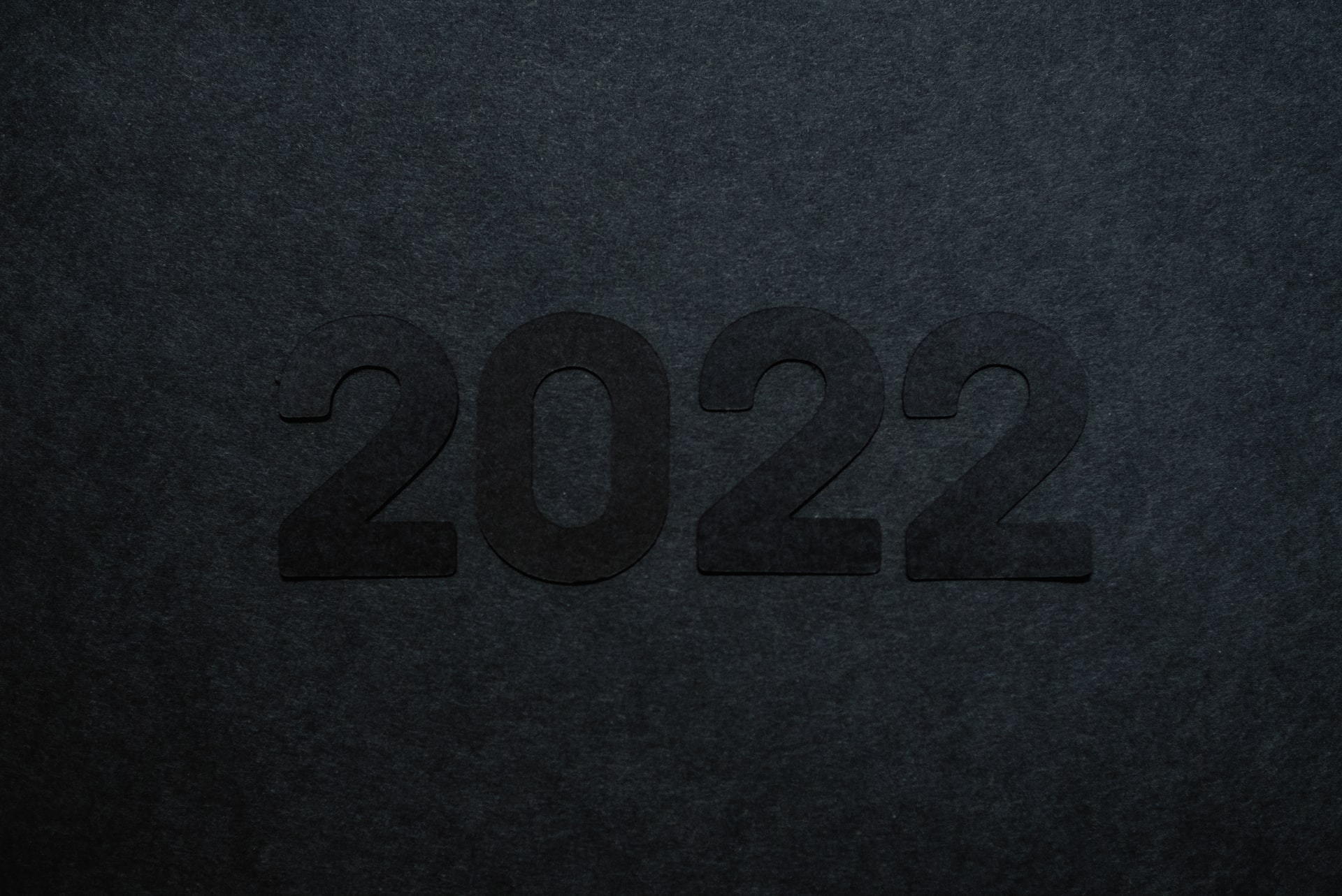 A photo of "2022" written in black letters against a grey background.