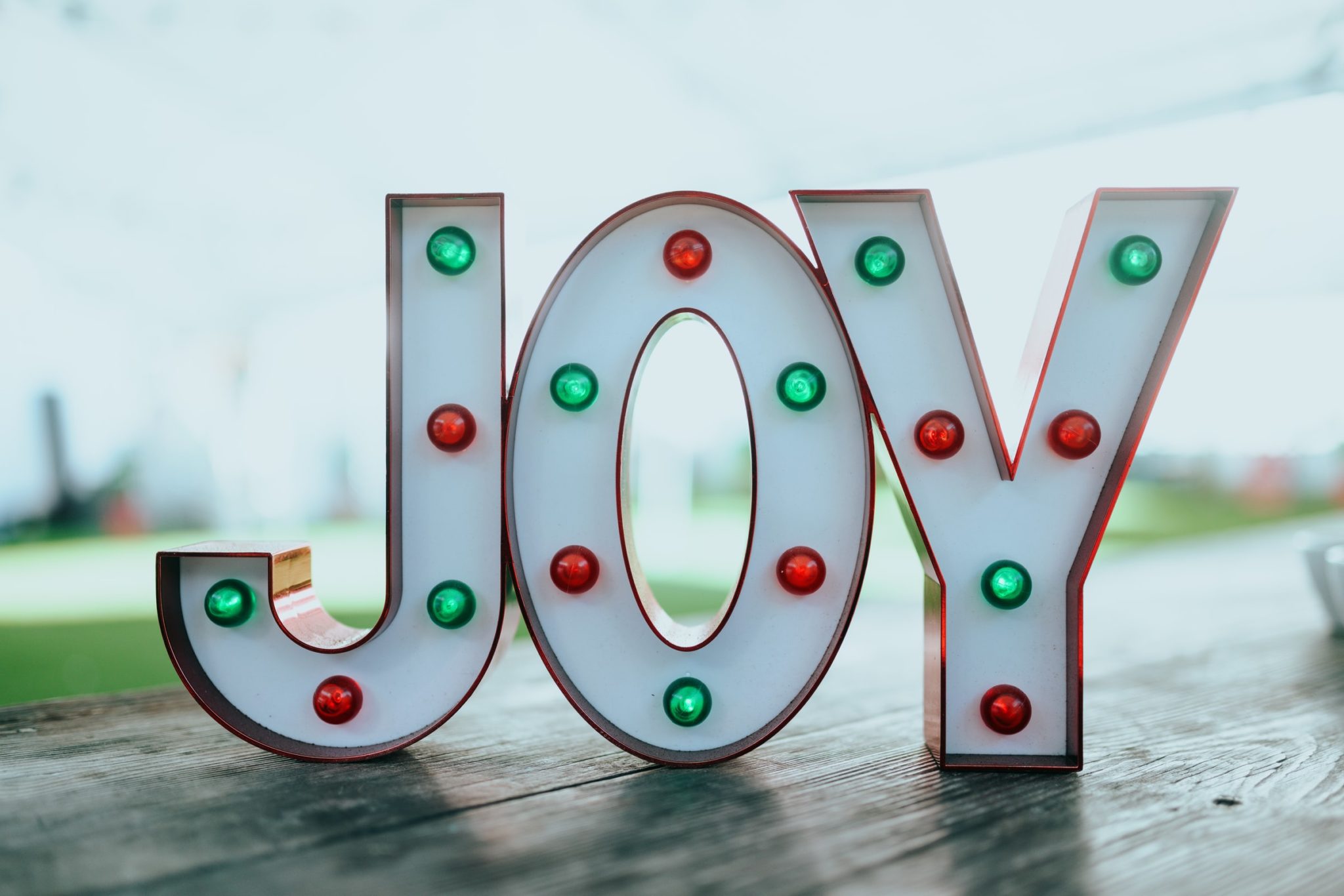Photo of the word joy spelled out using lightbox letters.