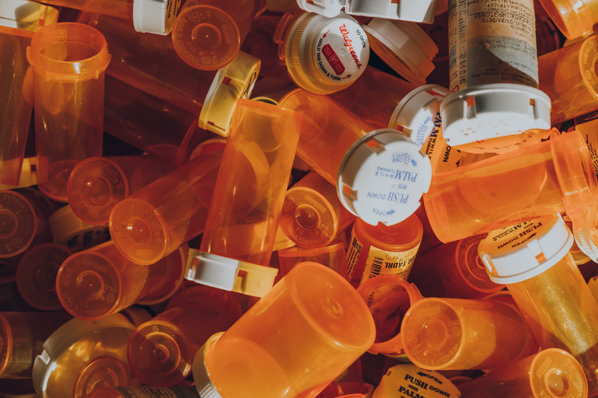 A photo of a pile of prescription pill bottles.