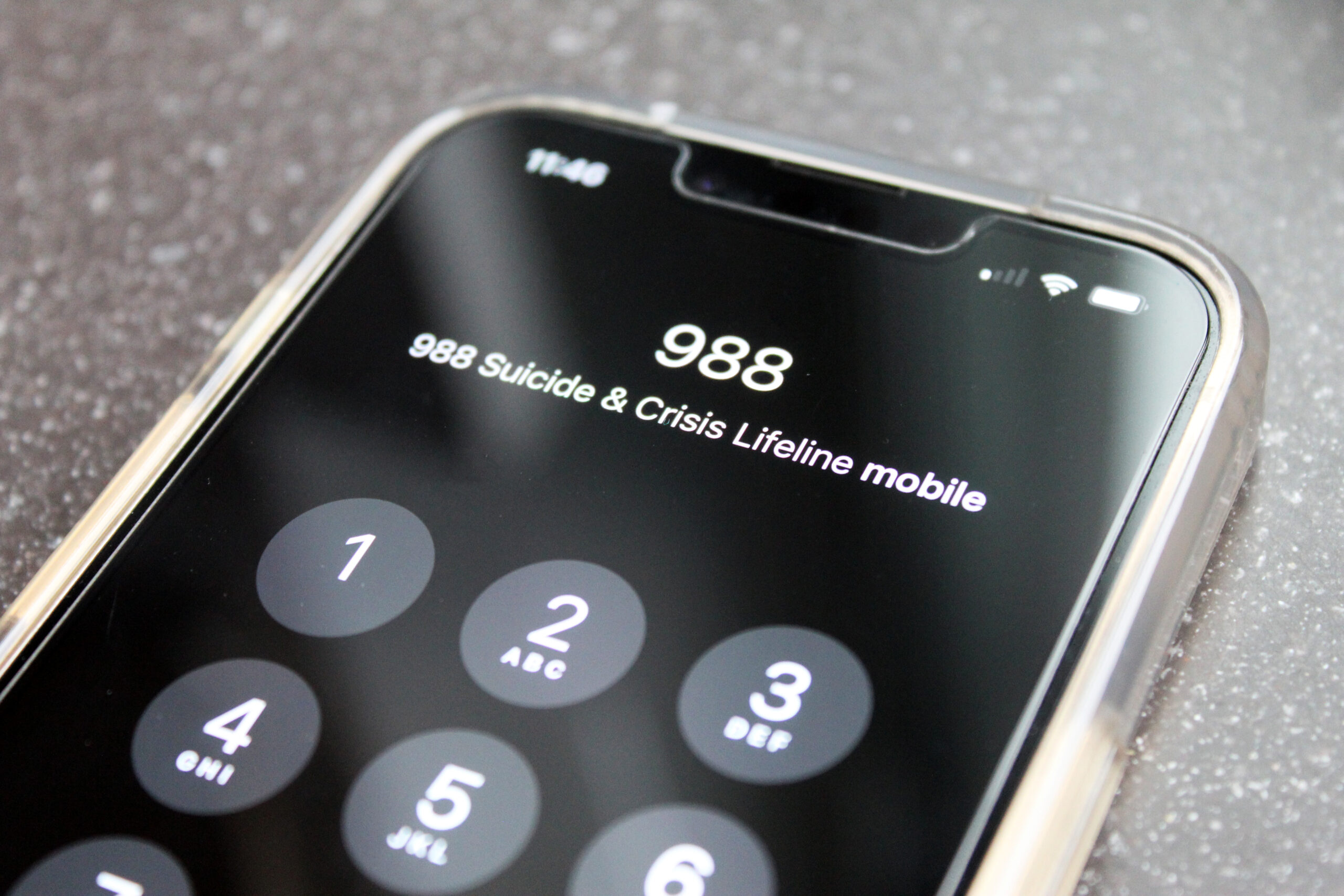 A phone dials 988 to access the national lifeline