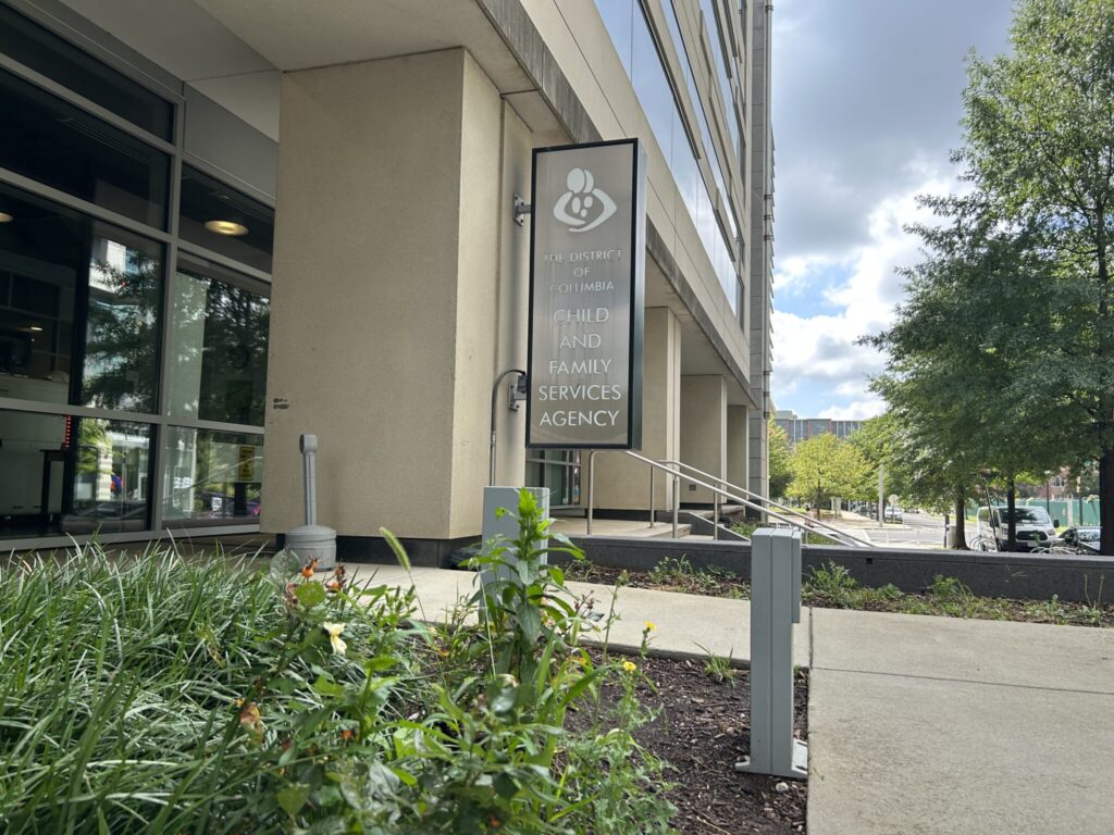 A silver sign on the side of a building reads "Child and Family Services Agency."