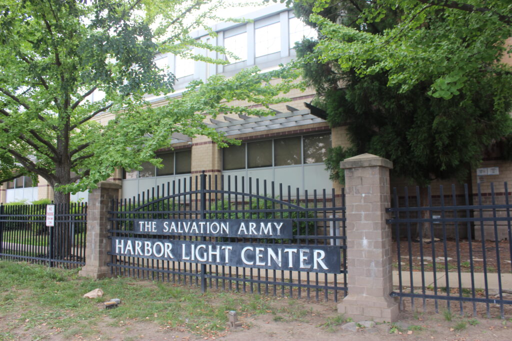 Gates in front of a building reading "The Salvation Army Harbor Light Center."