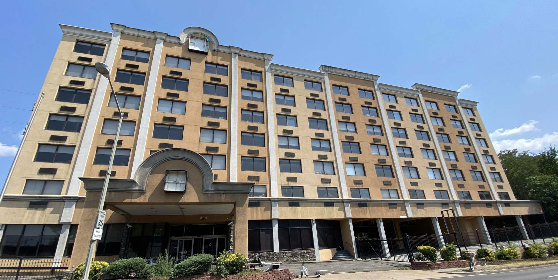 A large brown hotel building with the signage removed