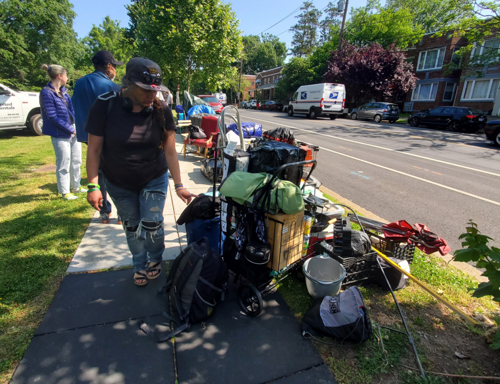 On May 25 at 10 a.m., Shelley Byars carried her belongings to the sidewalk while officials from the Office of the Deputy Mayor of Health and Human Services (DMHHS) cleared her encampment. Photo by Athiyah Azeem