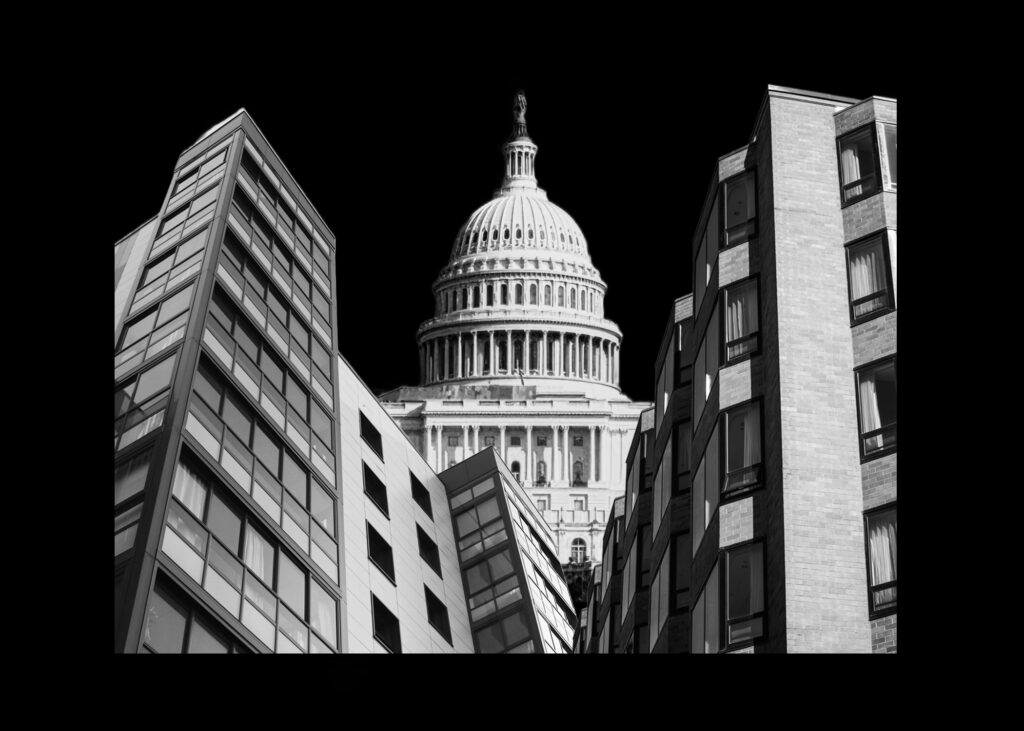 White buildings and the U.S. Capitol on a black background.
