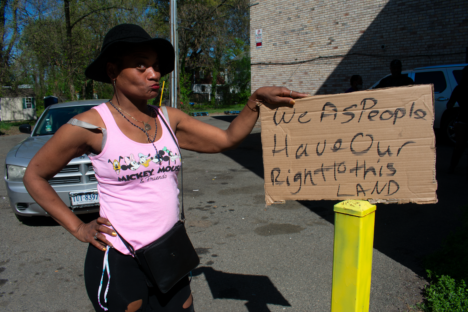 Sarita Forrest, an encampment resident protests the clearing on a nearby parking lot. Photo by Athiyah Azeem