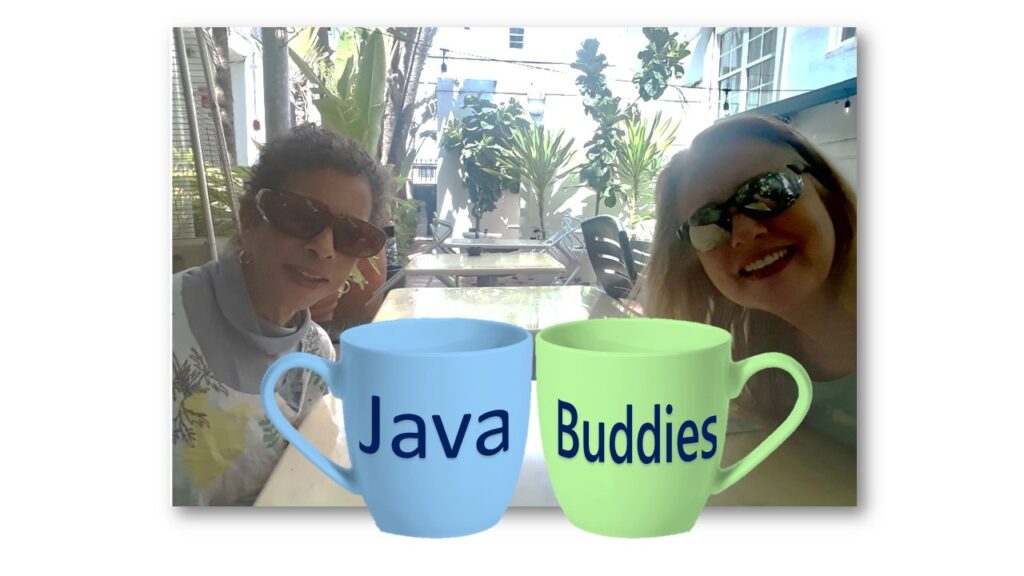 Two women with coffee cups in front of them